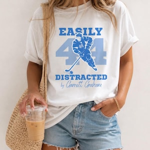 Garrett Graham shirt white tee Easily Distracted blue hockey player number 44 print, blonde model iced coffee tote