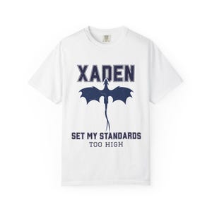 Xaden Riorson shirt white tee close-up navy dragon print, standing model in light wash jeans