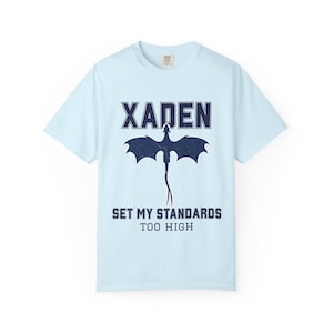 White Fourth Wing dragon tee close-up gray Xaden graphic, model in light blue jeans posing