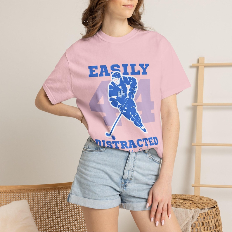 Pink tee blue Easily Distracted Garrett Graham 44 hockey player print, brunette model denim shorts boho setting