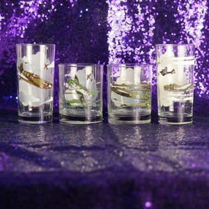 May include: A set of three ceramic nesting bowls. The largest bowl is light blue, the medium bowl is green, and the smallest is yellow. Each bowl has a smooth, glossy finish and a simple, modern design.