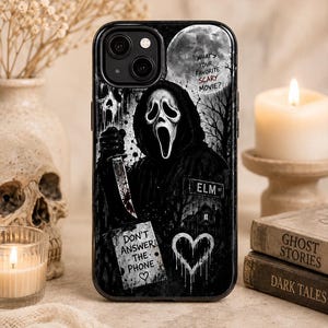 May include: A black smartphone case featuring a graphic of a masked figure holding a knife, a full moon, and the text "WHAT'S YOUR FAVORITE SCARY MOVIE?", "ELM ST", and "DON'T ANSWER THE PHONE" with a heart symbol, all set against a dark, moody background.