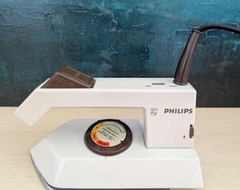 Plancha de vapor Philips TI6500 vintage para ropa de viaje con mango plegable.