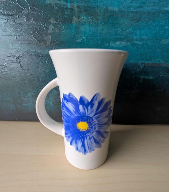 Pretty white coffee mug with a blue flower pattern. 16 oz.