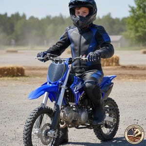 May include: A blue and black motorcycle with a rider wearing a black helmet and matching protective gear. The motorcycle has the Yamaha logo on the front. The rider is sitting on the motorcycle on a dirt road.