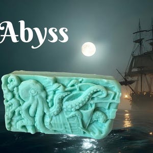 May include: A set of three ceramic mugs with a speckled, matte finish. The mugs are in shades of cream, light gray, and dark gray. Each mug has a simple, minimalist design and a rounded handle.