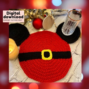May include: Red and black crochet coaster with a yellow buckle, shaped like Mickey Mouse's head.  Digital download crochet pattern only.