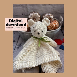 May include: A cream-colored crocheted lamb security blanket with a smiling face and green ribbon. The blanket has a textured pattern and the text "Digital download CROCHET PATTERN ONLY".