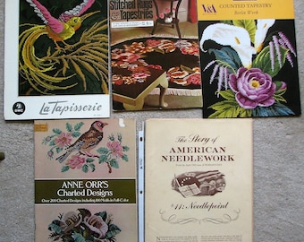 May include: A collection of vintage needlepoint and embroidery books. The books feature a variety of designs, including a bird, flowers, and a rug. The books are titled "La Tapisserie", "Patons Stitched Rugs & Tapestries", "Counted Tapestry Berlin Work", "The Story of American Needlework #11: Needlepoint", and "Anne Orr's Charted Designs".