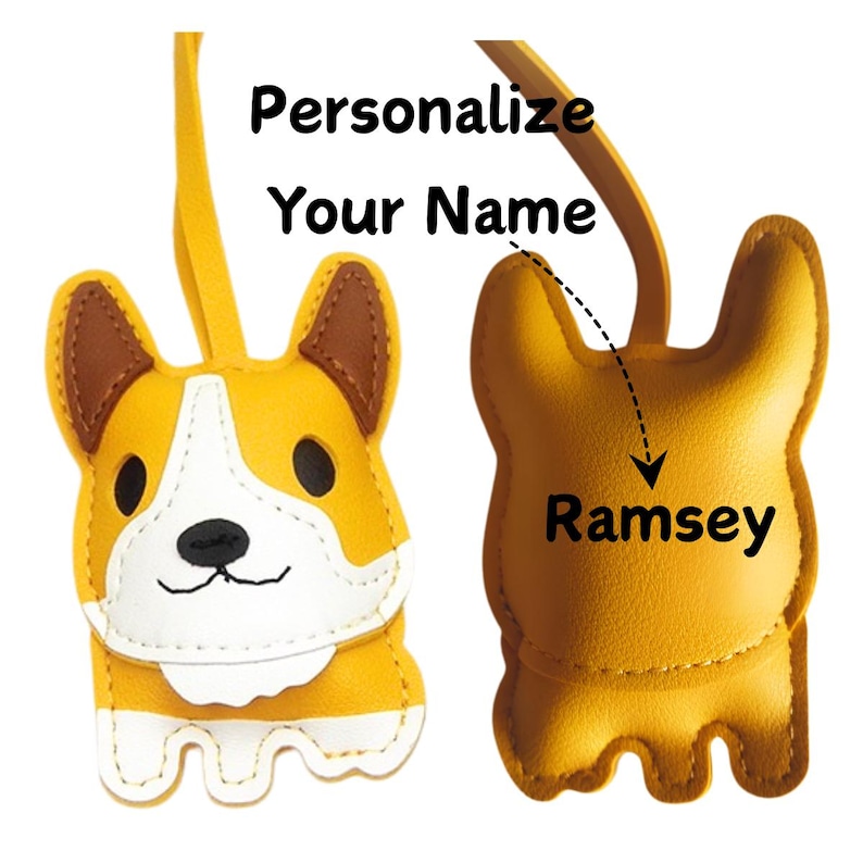 May include: A yellow and white corgi-shaped keychain with brown accents. The keychain has a leather strap and the text "Personalize Your Name" is above the keychain. The name "Ramsey" is written on the back of the keychain.