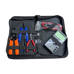 May include: A black zippered tool kit with various tools, including wire strippers, pliers, and a multimeter. The tools have orange, blue, and red handles. The kit is open, revealing the organized tools.