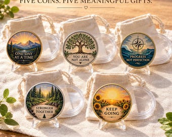 May include: Five round metal coins with colorful illustrations and text, each displayed on a clear plastic stand with a matching drawstring pouch and protective capsule. The coins feature designs of mountains, a tree, a compass, a forest, and sunflowers.