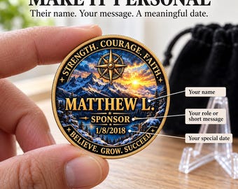 May include: A round gold-toned commemorative coin featuring a mountain landscape at sunrise, a compass rose, and the text STRENGTH, COURAGE, FAITH, MATTHEW L, SPONSOR, 1/8/2018, and BELIEVE, GROW, SUCCEED. The coin includes labels for name, role, and date.