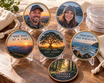 May include: Six circular custom tokens with metallic rims displayed on clear stands. Two feature portraits, while four display landscapes with text: ONE DAY AT A TIME, YOU ARE NOT ALONE, PROGRESS NOT PERFECTION, and STRONGER TOGETHER. Text reads: YOUR PHOTOS. YOUR STORIES.