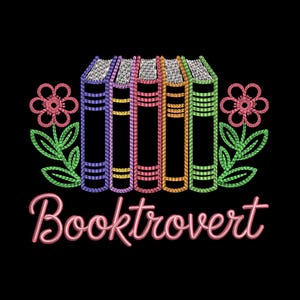 May include: Embroidered design on a black background featuring a row of colorful books with floral accents. The word "Booktrovert" is written in a cursive font below the books. The books are in shades of purple, pink, orange, and green.