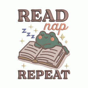 May include: An embroidered design featuring a sleeping frog on an open book. The text reads "READ nap REPEAT" in brown and peach colors, with star and "zzz" accents. The design is on a white background.
