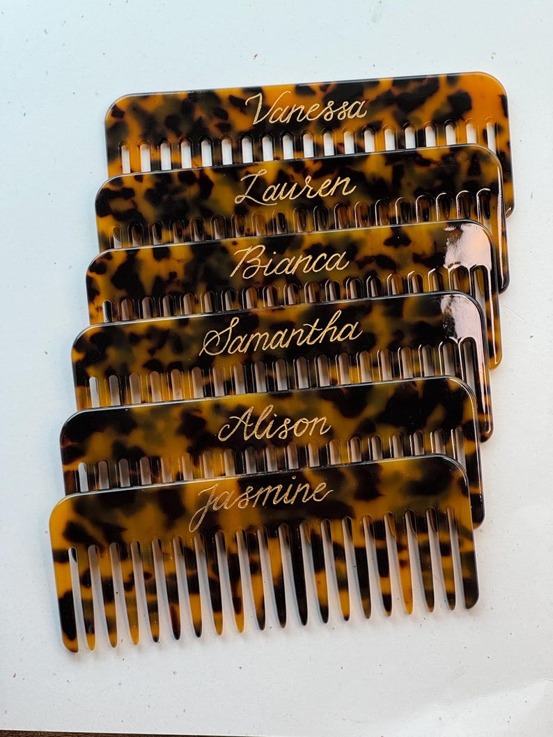 May include: Six tortoiseshell-patterned combs, each engraved with a name: Vanessa, Lauren, Bianca, Samantha, Alison, and Jasmine. The combs have fine teeth and a curved top. A personalised hair accessory.