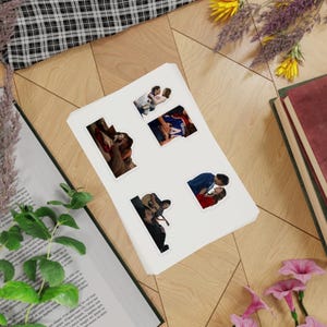 May include: A sticker sheet featuring four distinct die-cut stickers, each displaying a different scene of a couple in an intimate embrace. The stickers are arranged on a white rectangular backing sheet, showcasing various romantic poses and clothing styles.
