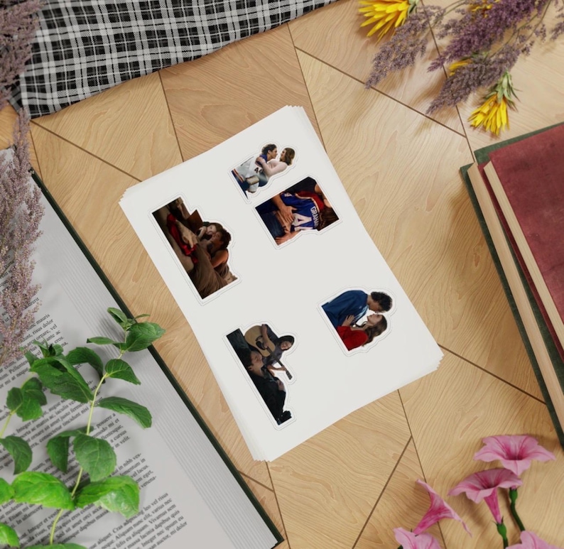 May include: A sticker sheet featuring four distinct die-cut stickers, each displaying a different scene of a couple in an intimate embrace. The stickers are arranged on a white rectangular backing sheet, showcasing various romantic poses and clothing styles.
