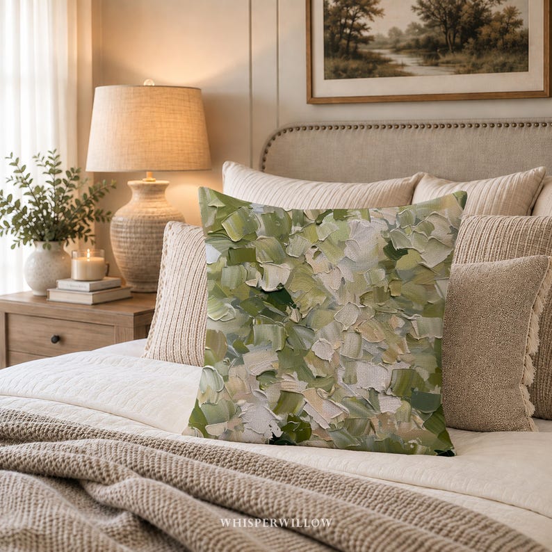 May include: A square throw pillow featuring an abstract pattern of thick, textured paint strokes in various shades of sage green, olive, cream, and white. The design covers the entire front surface with a layered, impasto-style appearance.
