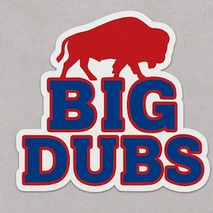 May include: A sticker featuring a red buffalo silhouette above the words "BIG DUBS" in blue letters with a red outline. The sticker has a white border and is on a light gray background.