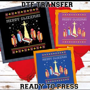 May include: Three DTF transfer designs featuring a Christmas-themed graphic. The designs include the text "MERRY GLIZZMAS" and a nativity scene with hot dogs as characters. The transfers are ready to press.