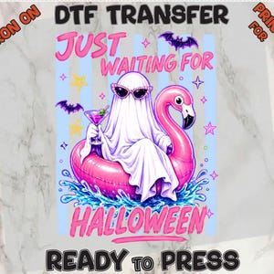 May include: A DTF transfer print featuring a white ghost wearing cat-eye sunglasses, sitting in a pink flamingo pool float, holding a martini glass. The text reads "JUST WAITING FOR HALLOWEEN" with purple bats and yellow stars on a light blue striped background.