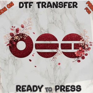 May include: DTF transfer with the word "OEE" in a glittery red font, decorated with floral accents. The words "Iron On" and "Print For" are in the corners, and "Ready to Press" is at the bottom. The background is a marble pattern.
