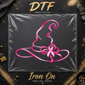 May include: A pink witch hat graphic transfer featuring a ribbon bow and a breast cancer awareness ribbon. The design is printed on a clear film sheet with the text DTF DIRECT TO FILM and IRON ON PRESS, PEEL, PERFECT printed in gold lettering.
