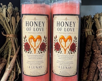 May include: Two tall, cylindrical glass candles filled with pink wax. Each features a label reading Honey of Love Prepared Candle, with a central dripping honey heart graphic flanked by red roses. The text includes instructions in English and Spanish.