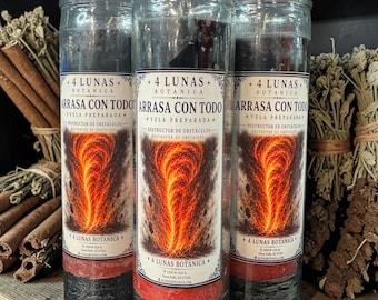 May include: Three tall cylindrical glass candles with black and red wax layers. Each label features the text 4 LUNAS BOTANICA, ARRASA CON TODO, VELA PREPARADA, and DESTRUCTOR DE OBSTÁCULOS, alongside a graphic of a fiery orange and red tornado.