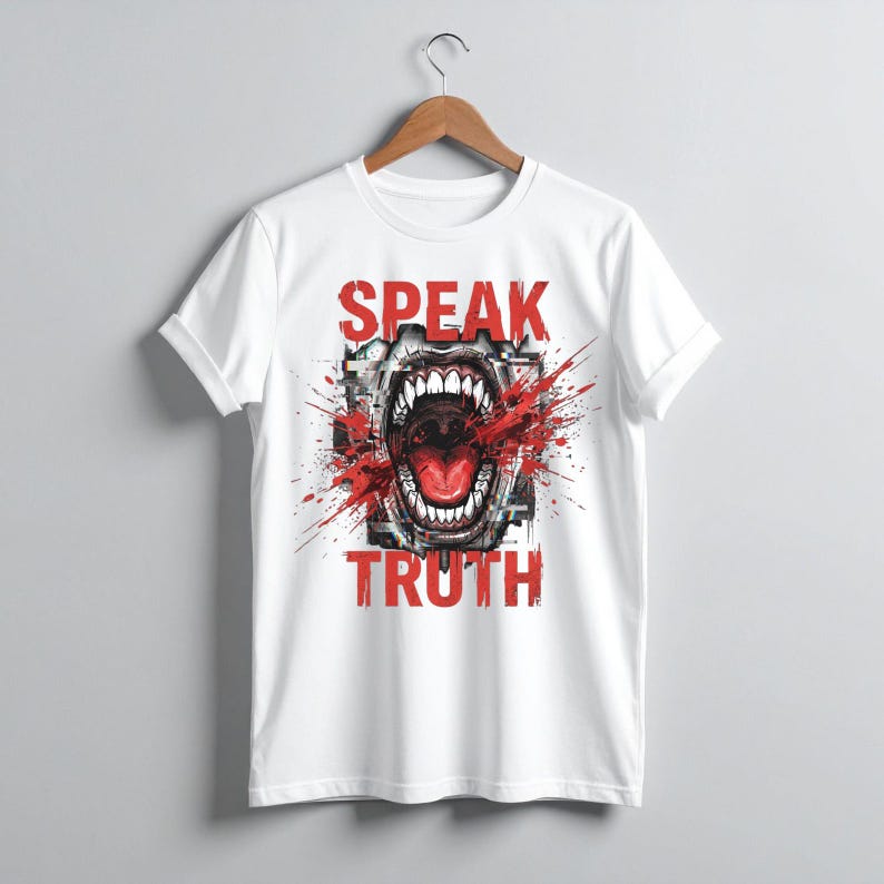 May include: A white short-sleeve t-shirt featuring a graphic print of an open mouth with sharp teeth, surrounded by red paint splatter effects and the text "SPEAK TRUTH" in bold red capital letters centered on the front of the garment.
