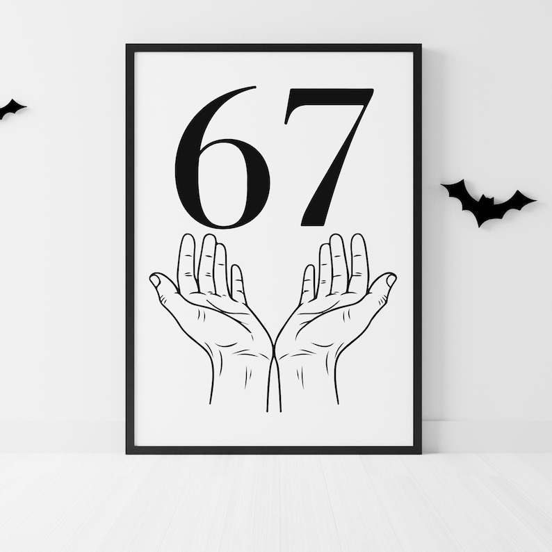May include: Black framed print featuring the number 67 in bold black font above a detailed line drawing of two open hands. Two black bat silhouettes are on the white wall. The print is on a white background.