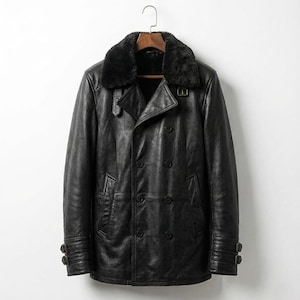 May include: A black leather coat with a double-breasted design, featuring a shearling collar and buckle details on the cuffs. The coat is hanging on a wooden hanger against a white background.