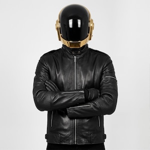 May include: A set of three ceramic mugs with a speckled, matte finish. The mugs are in shades of cream, light gray, and dark gray. Each mug has a simple, minimalist design and a rounded handle.