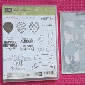 May include: A Stampin' Up! Balloon Adventures clear stamp set featuring balloon, confetti, and banner designs with phrases like THE BEST IS YET TO COME and HAPPY BIRTHDAY, alongside a matching set of silver metal Balloon Pop-Up Thinlits dies.