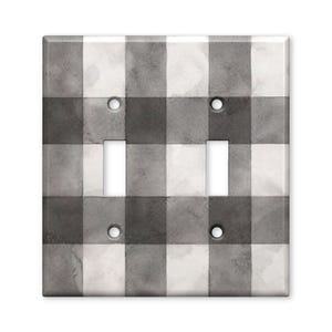 May include: A double light switch wall plate featuring a gray and white watercolor buffalo check pattern. The rectangular cover has two vertical rectangular cutouts for switches and four circular holes for mounting screws in a grid arrangement.