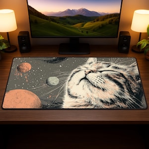 May include: A rectangular mouse pad featuring a cat's face with closed eyes, set against a space-themed background with planets and stars. The color palette includes shades of gray, orange, and white, creating a whimsical design.