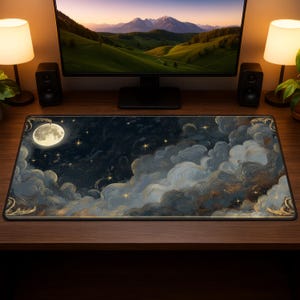 May include: A rectangular desk mat featuring a night sky design with a full moon, stars, and fluffy clouds in shades of blue, gray, and gold. The mat has a black border and is placed on a wooden desk.