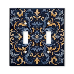 May include: A square double light switch wall plate featuring a dark navy blue background with a symmetrical, intricate acanthus leaf pattern in shades of gold, light blue, and white. The plate has two rectangular cutouts and four screw holes.