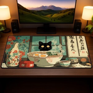 May include: A decorative desk mat featuring a Japanese-inspired design. The mat showcases a bowl of ramen with eggs, a black cat, and traditional Japanese elements. The color palette includes shades of green, red, and white, creating a visually appealing aesthetic.