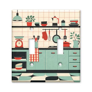 May include: A double light switch plate featuring a kitchen illustration with mint green cabinets, a red and white checkered towel, a red scale, a black frying pan, a red pot, and various kitchen utensils against a tiled wall background.
