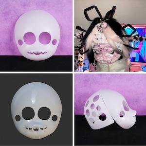 May include: Four white, blank masks with eye and mouth cutouts. One mask is whole, while another is split in two. The masks have a smooth, matte finish and are designed for customization. The background is a mix of black and purple.