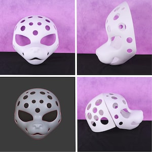 May include: A white, spotted, blank animal mask with large eye openings and a snout. The mask is shown in multiple views, including a front-facing and side profile. The mask has several circular cutouts.
