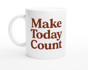 May include: White ceramic mug with a curved handle. The mug features the phrase "Make Today Count" in a bold, brown font. The mug is designed for hot beverages.