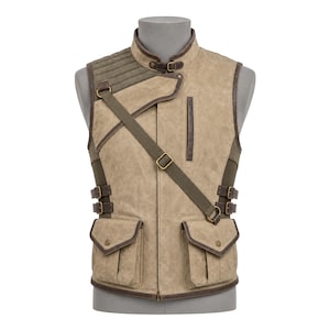 May include: A tan utility vest featuring a high collar with a buckle closure, a quilted shoulder panel, and a diagonal strap across the chest. The vest includes two large front pockets with flaps, side buckle adjustments, and dark brown trim.