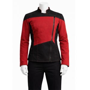 May include: A red and black jacket with a diagonal zip. The jacket has a stand-up collar and a colour-blocked design, with red panels on the upper chest and sleeves, and black panels on the lower body. The jacket is displayed on a mannequin.