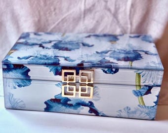 Glass overlay wood jewelry box with blue irises and gold tone latch.
