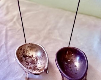Vintage metal egg poachers.