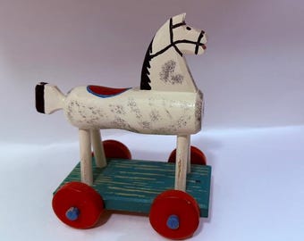 Vintage folk art horse with wheels. Hand painted and unique.